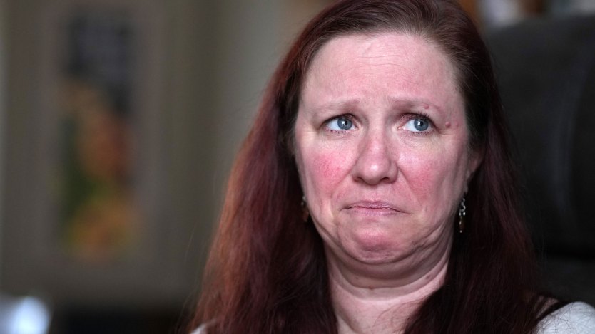A close-up portrait of an emotional woman looking off-camera.