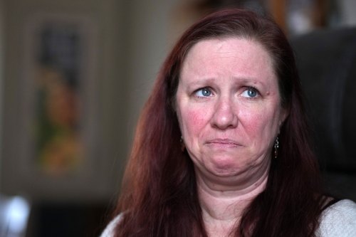 A close-up portrait of an emotional woman looking off-camera.
