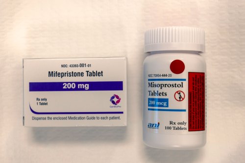 A rectangular box of one 200mg mifepristone tablet is shown beside a bottle of 100 200mcg misoprostol tablets.