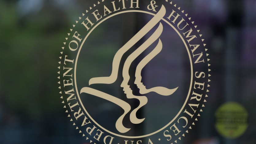 An image of the Department of Health and Human Services seal on a pane of glass.