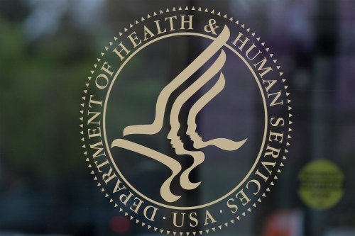An image of the Department of Health and Human Services seal on a pane of glass.