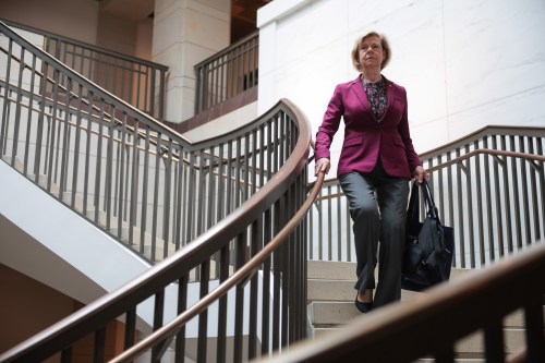 A photo of Sen. Tammy Baldwin descending a staircase.