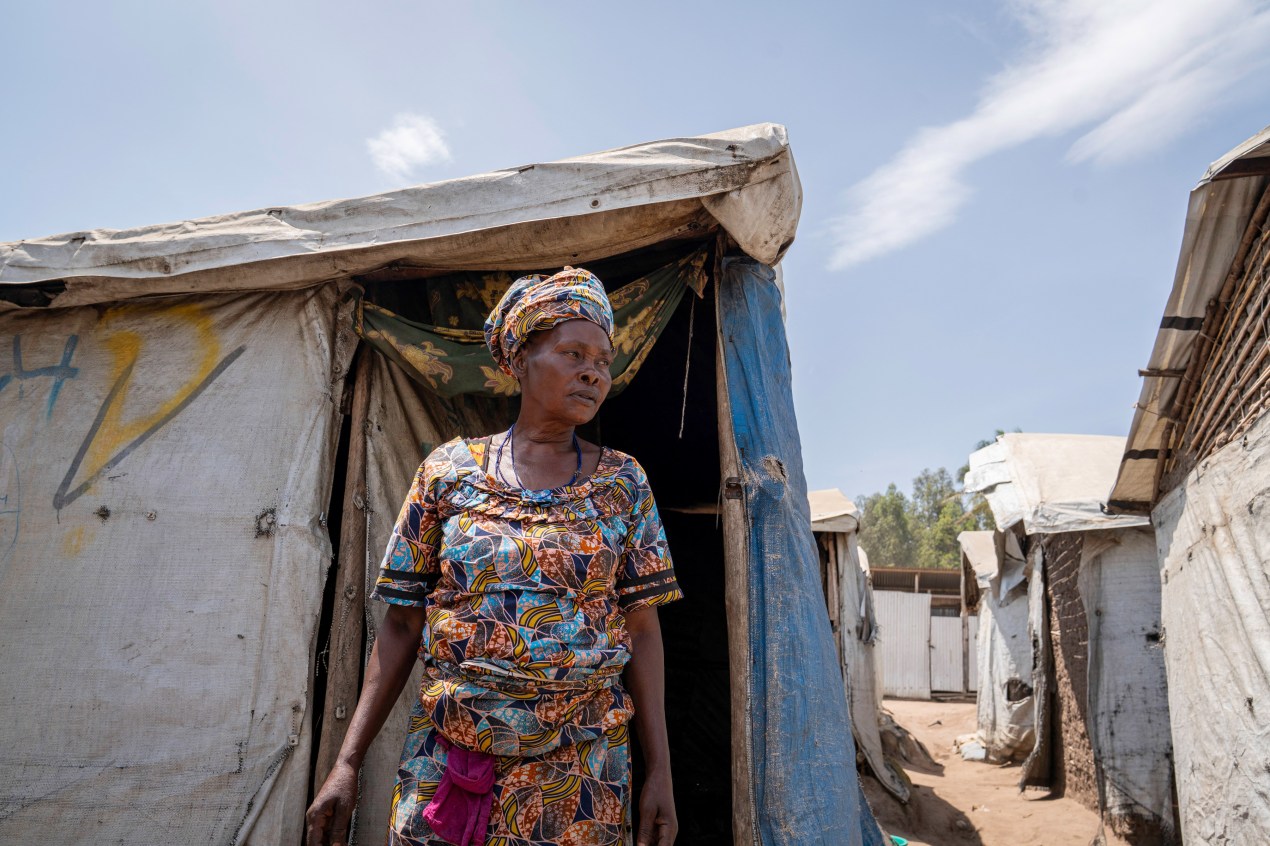 A woman walks out of a tent set up during the Ebola outbreak in Congo.