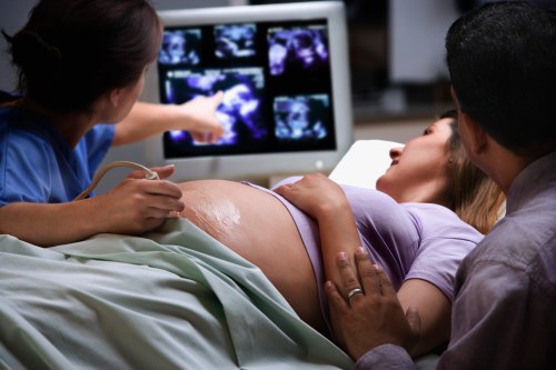 A pregnant woman receives an ultrasound.