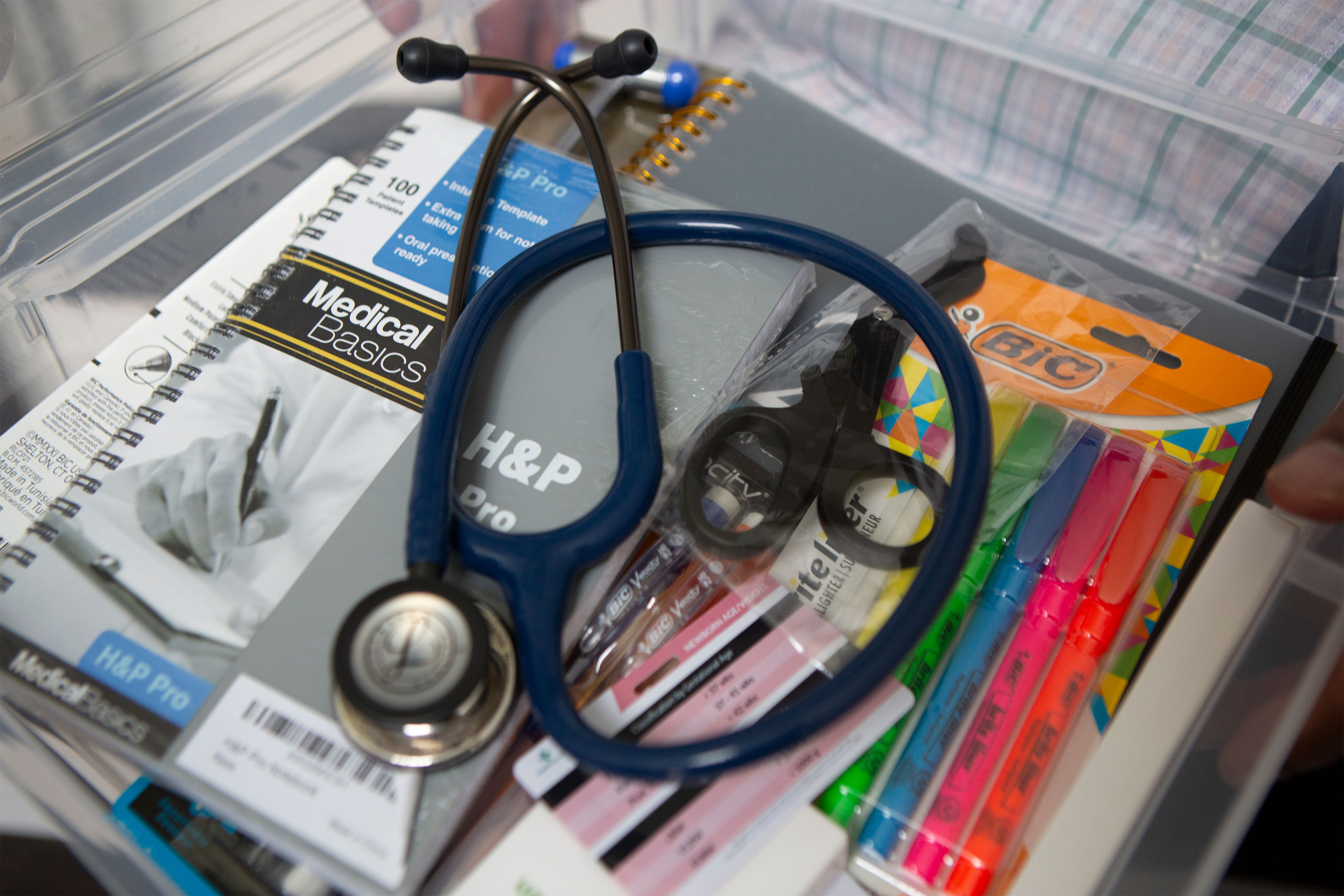 Inside Pinckney's "PA School Starter Kit": a stethoscope, a medical notebook, a set of highlighters, scissors.
