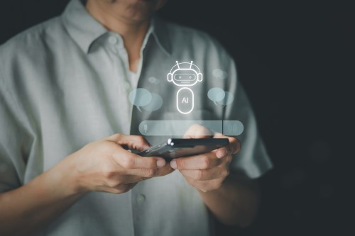 A person holds a smartphone with an AI chatbot interface overlay