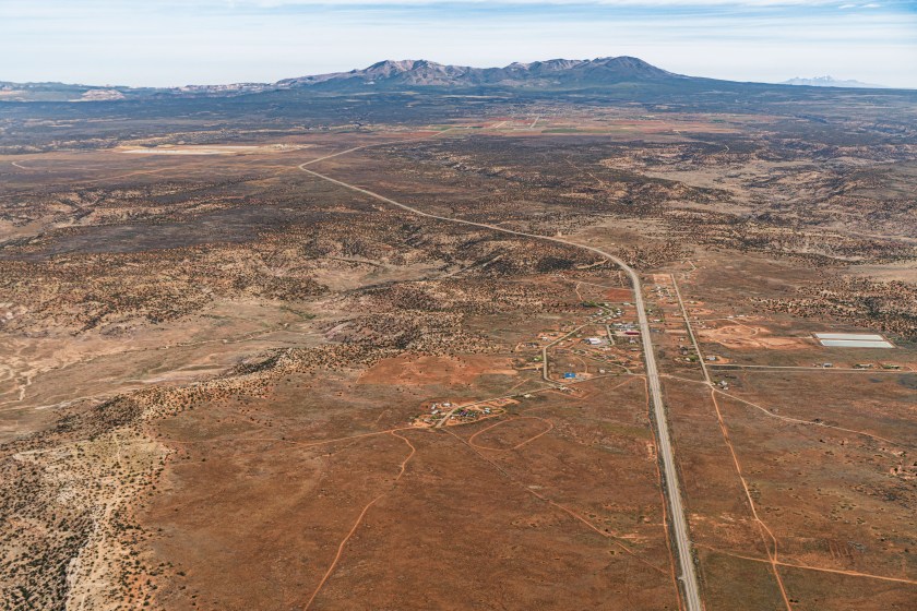 An aerial view of a desert community with mountains in the distance.