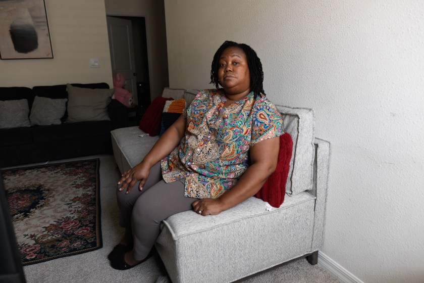 A woman sits on a couch
