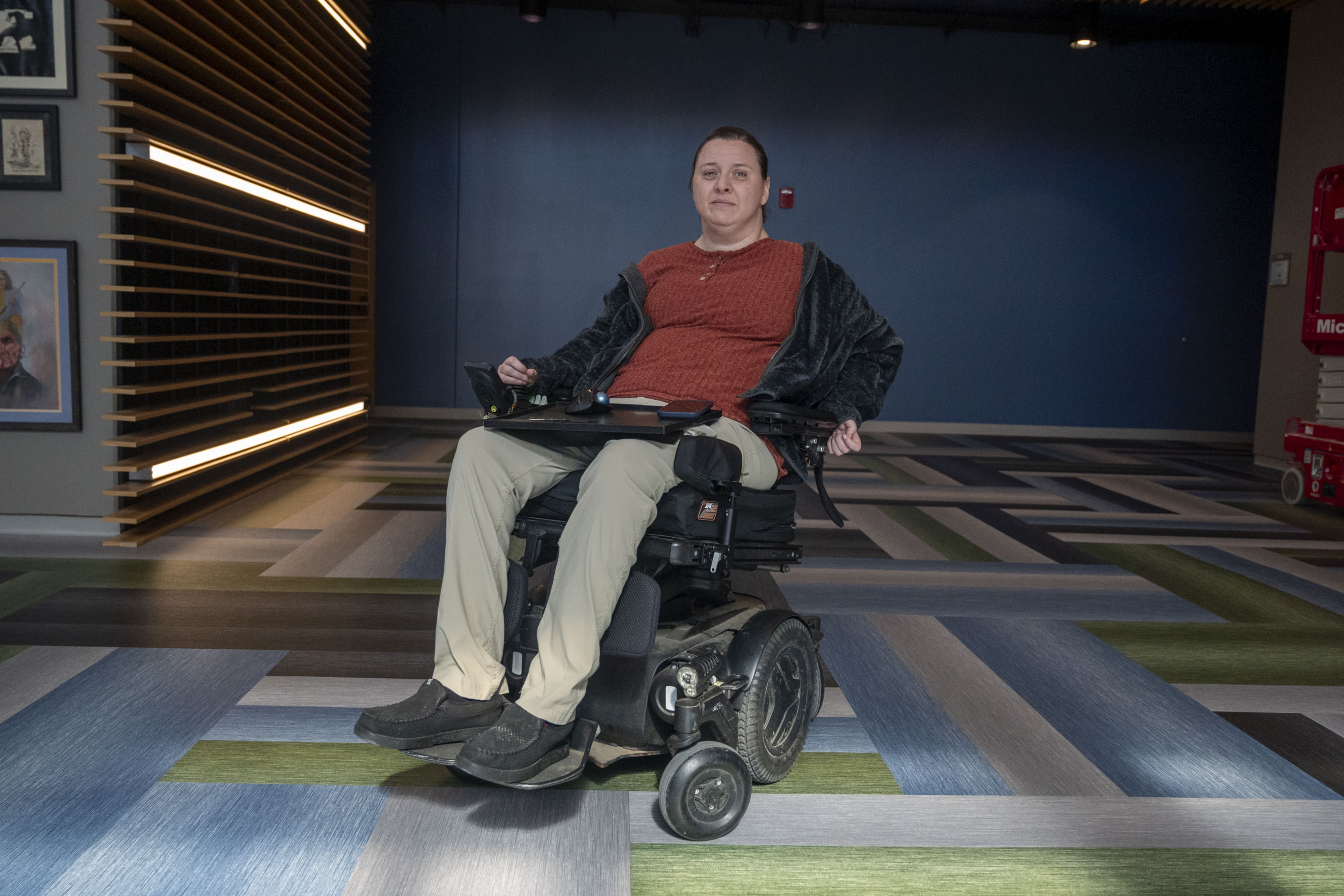 A woman sits for a photo in her wheelchair.