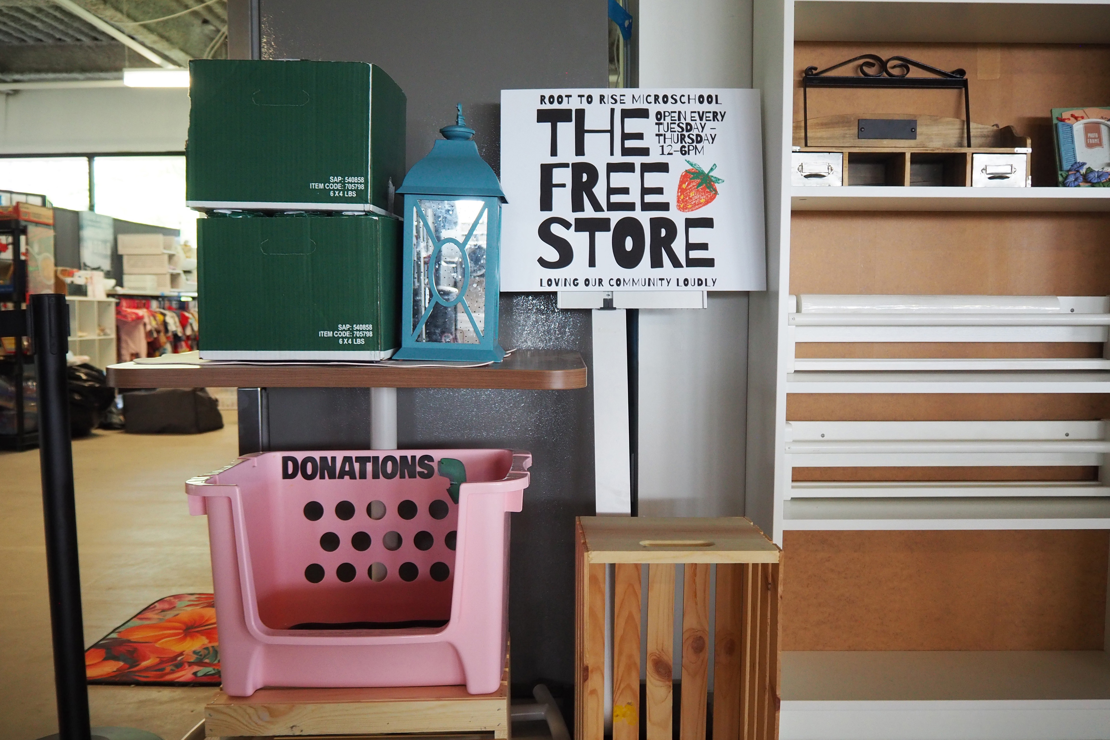 A sign in the middle of the image reads "The Free Store" and "Open every Tuesday-Thursday 12-6pm"