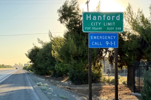 A highway sign shows the city limit for Hanford, California.