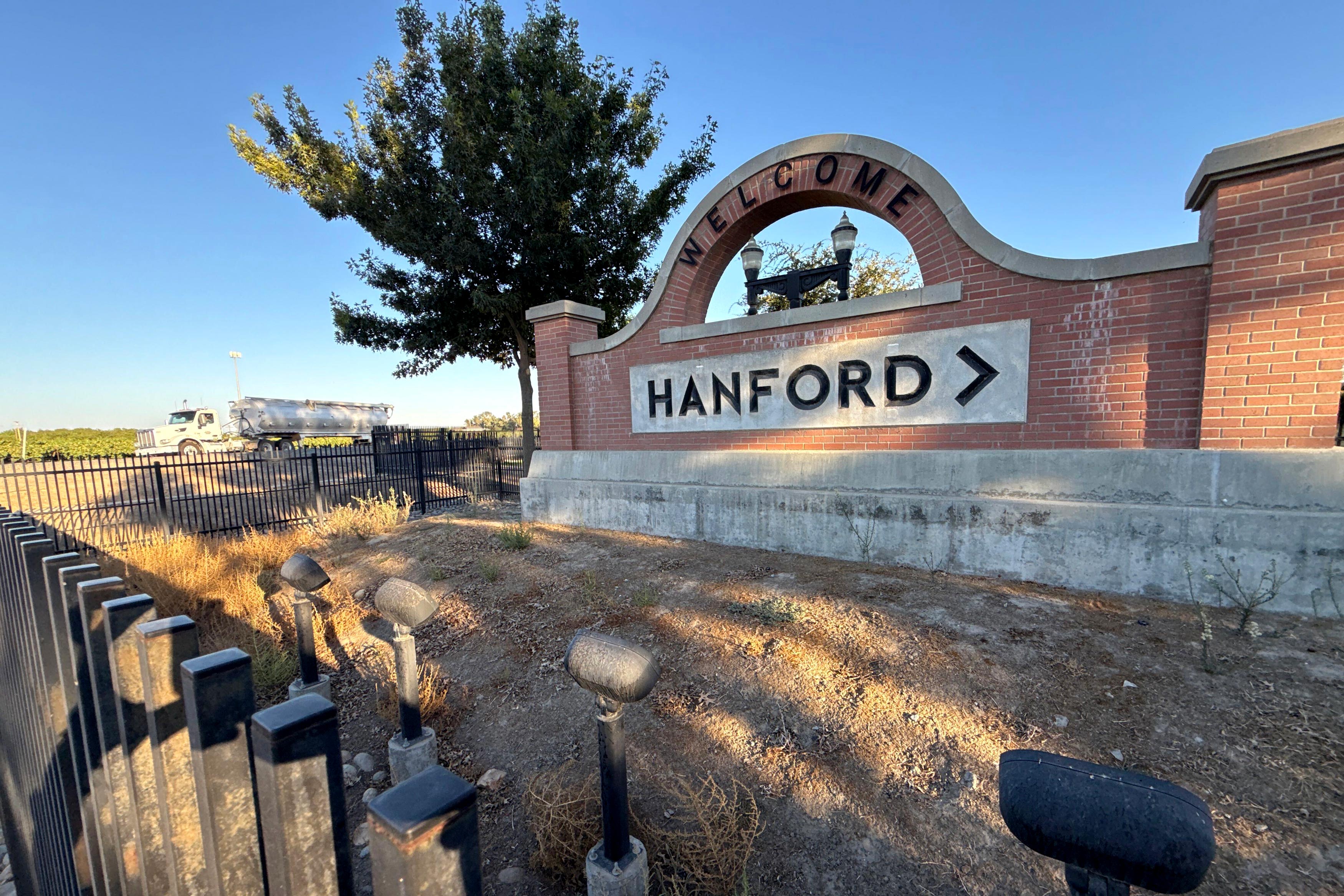 A photo shows a sign for the city of Hanford.
