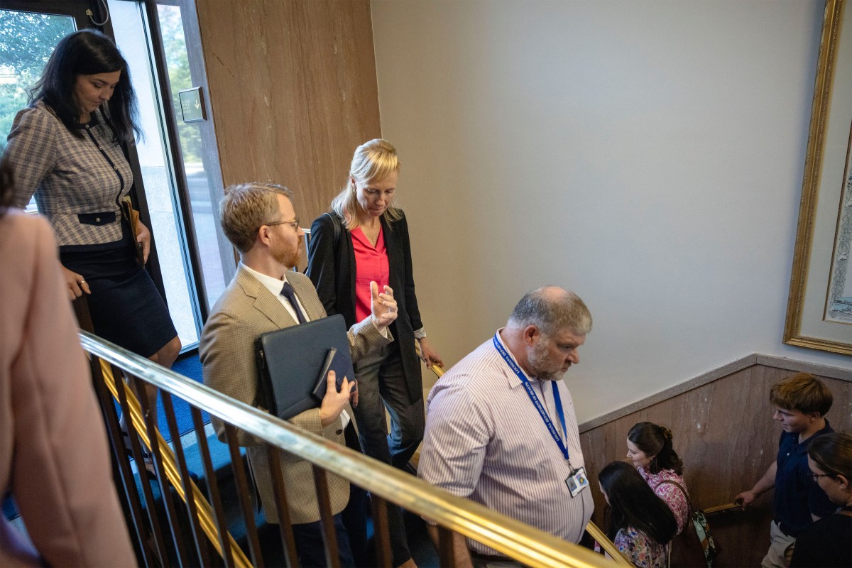 A photo of Benjamin Clapper speak to Evelyn Griffin as they walk into the Louisiana Capitol.