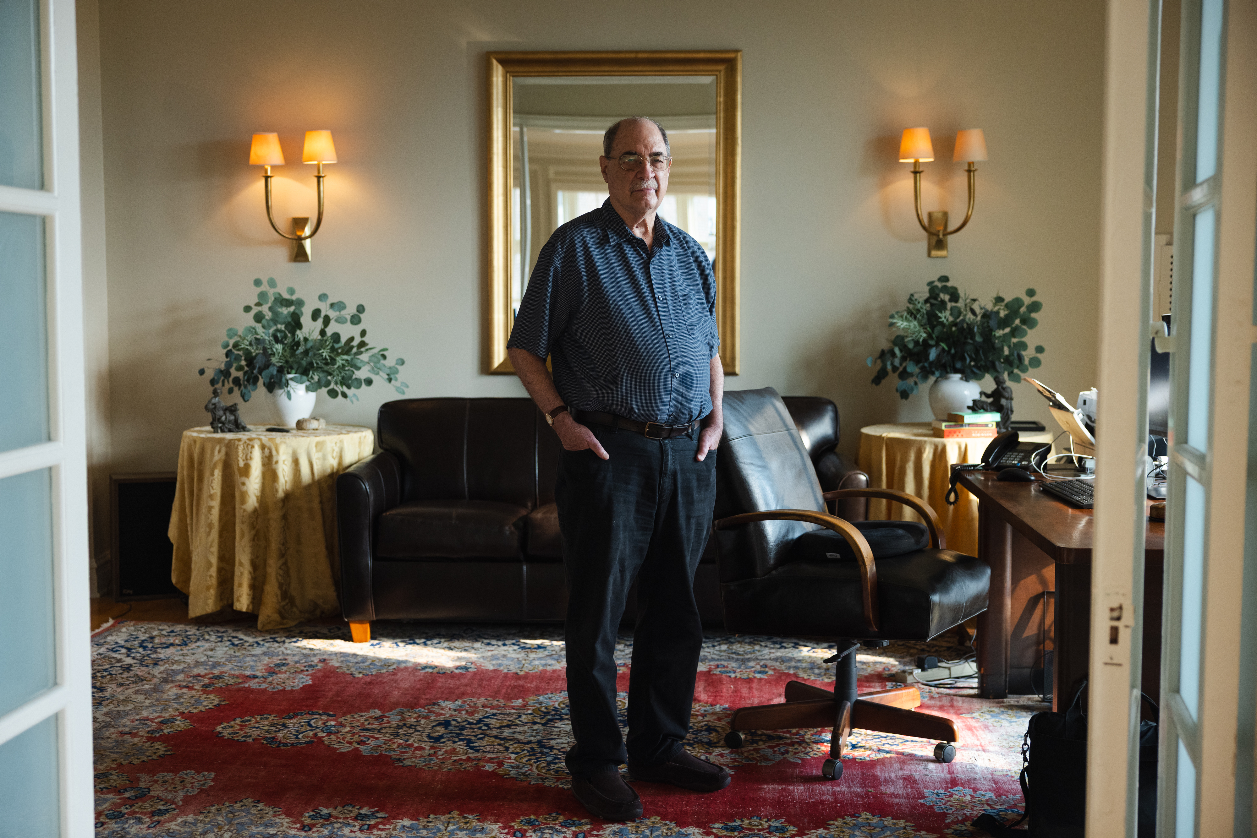 A photo of Chuck Mansku standing in his home.