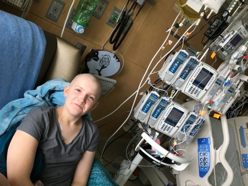 Hailstone is seen without hair in a hospital room.