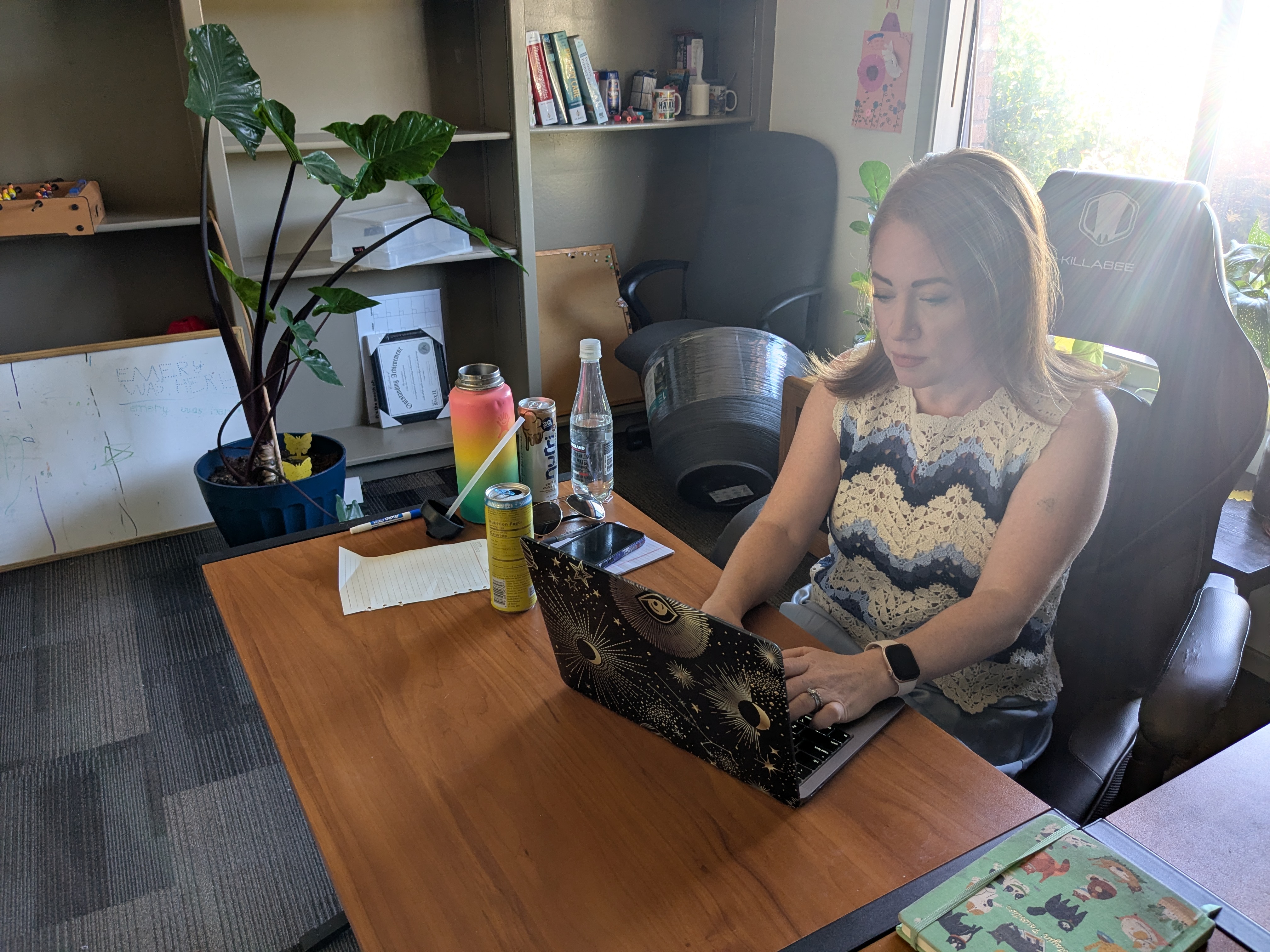 Samantha LeGault works on a laptop indoors.