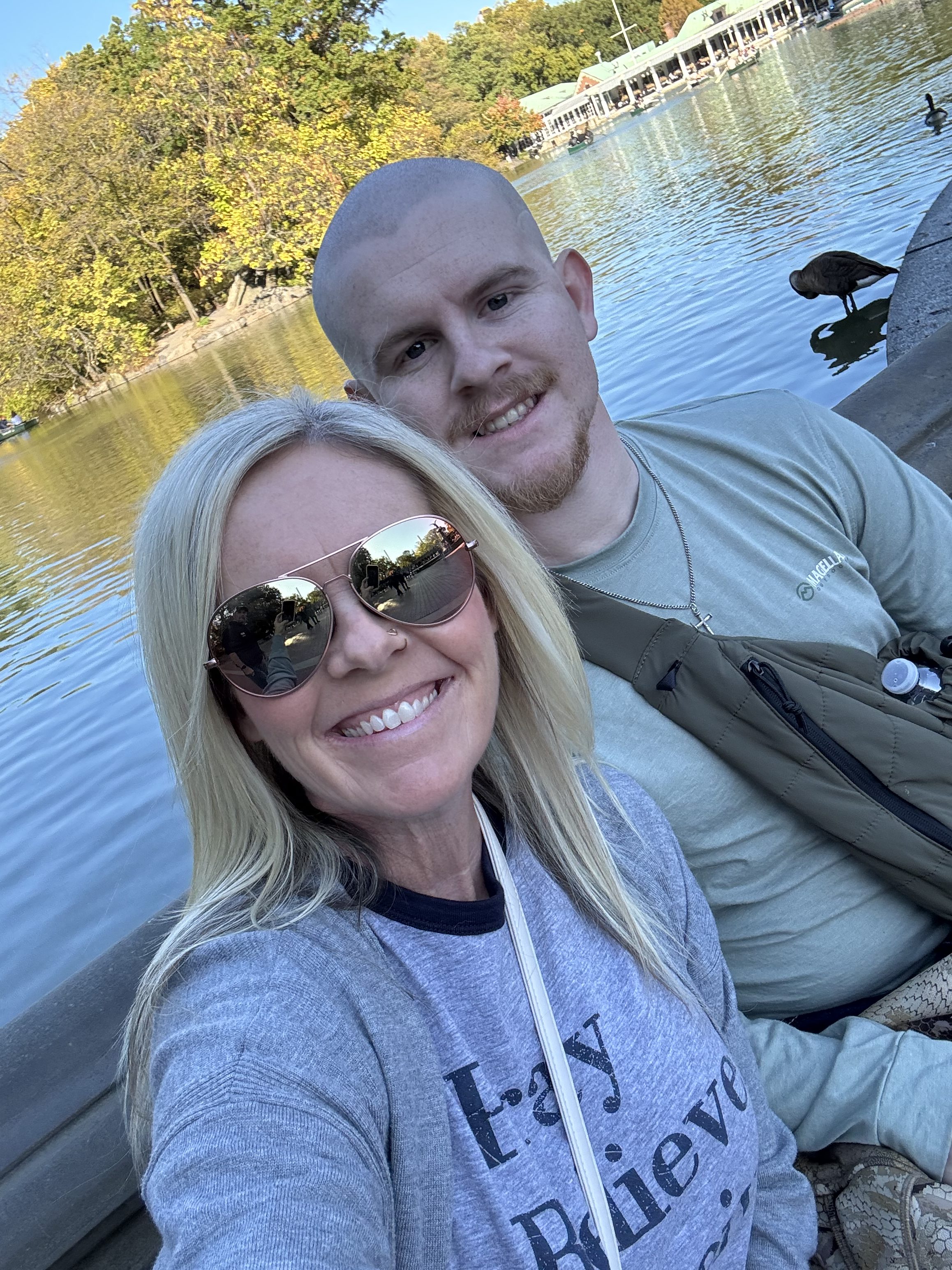 A photo of Tabitha Lowe and her son Mason Henderson smiling by a lake.