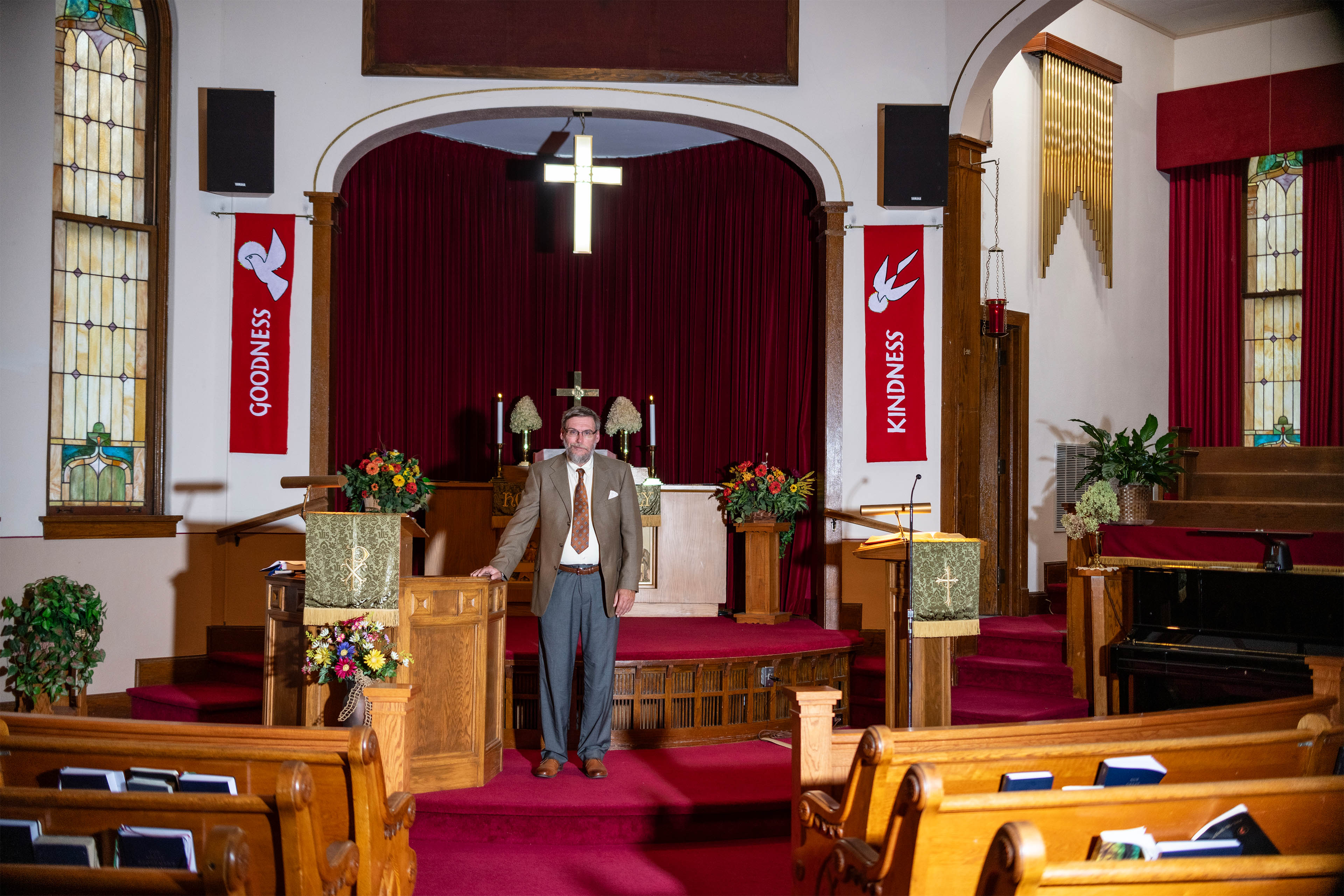 A photo of Mike Jager standing in front of an altar inside of a church.