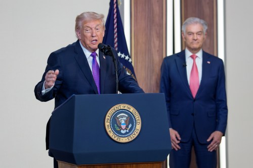 A photo of President Donald Trump speaking at a podium by Mehmet Oz in the South Court Auditorium of the Eisenhower Executive Office Building at the White House.