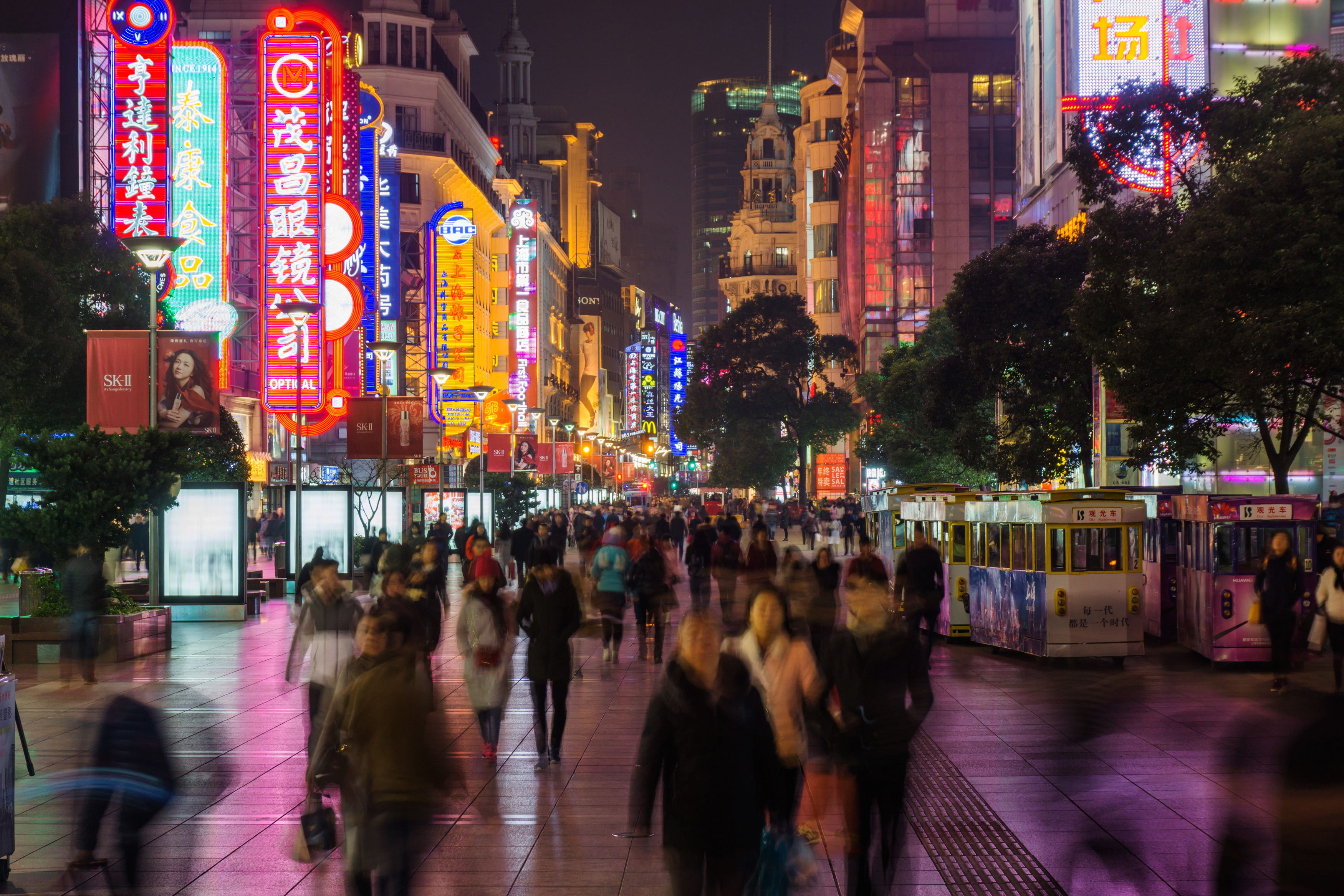 A view of hundreds of people walking a street in Shanghai, China.